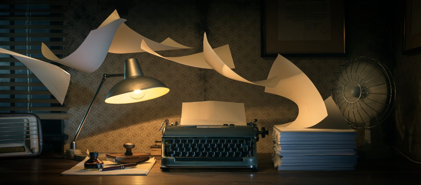 Vintage writer's desktop with flying sheets